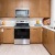 Model kitchen at our 55+ senior community in Palm Desert, featuring wood grain cabinetry and stainless steel appliances.